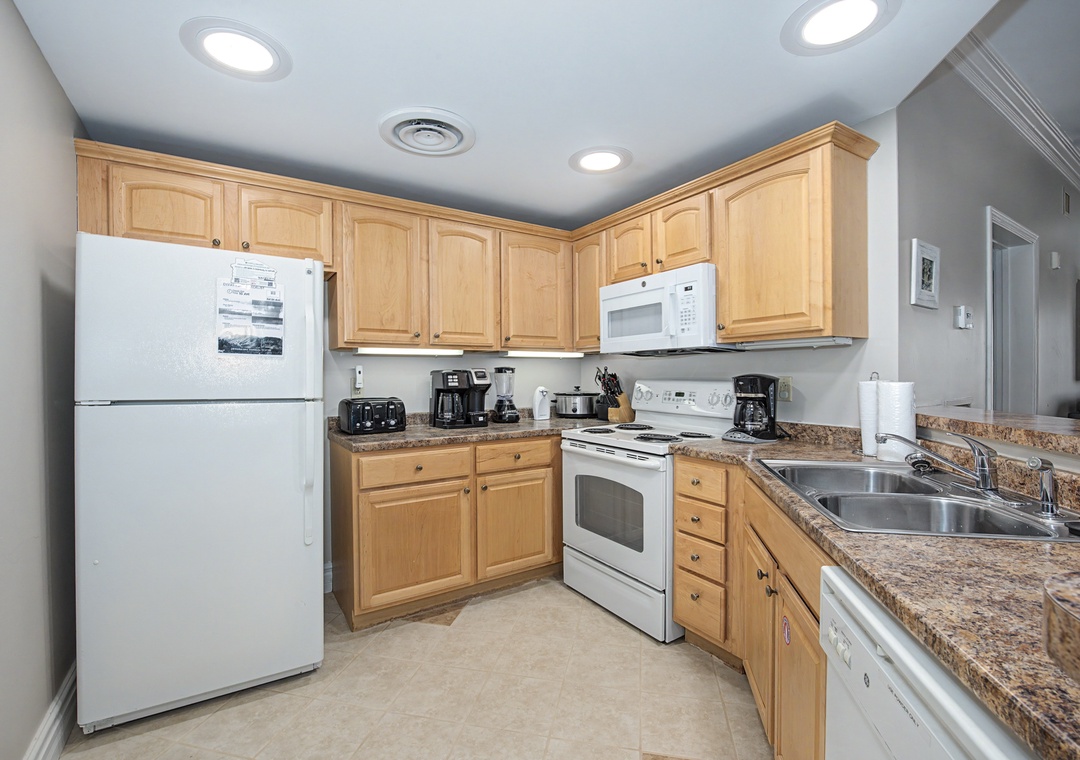 Your fully equipped kitchen features warm wood cabinets, granite countertops, and all the appliances you need to create memorable meals.