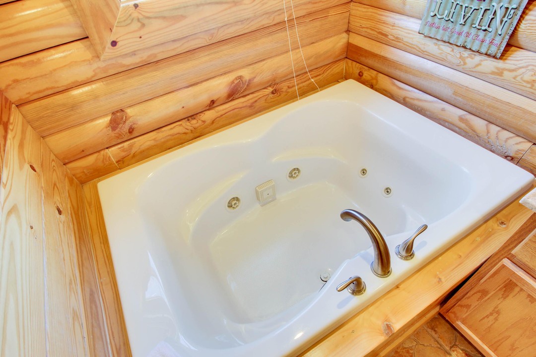 Slip into your private jetted tub, surrounded by warm wood paneling that brings rustic charm and total relaxation to your retreat.