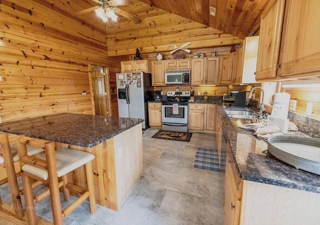 Step into your spacious cabin kitchen, featuring sleek granite counters, full stainless appliances, and warm wood accents throughout. Whether you're brewing morning coffee or prepping a hearty meal, this inviting space makes cooking feel effortless and co