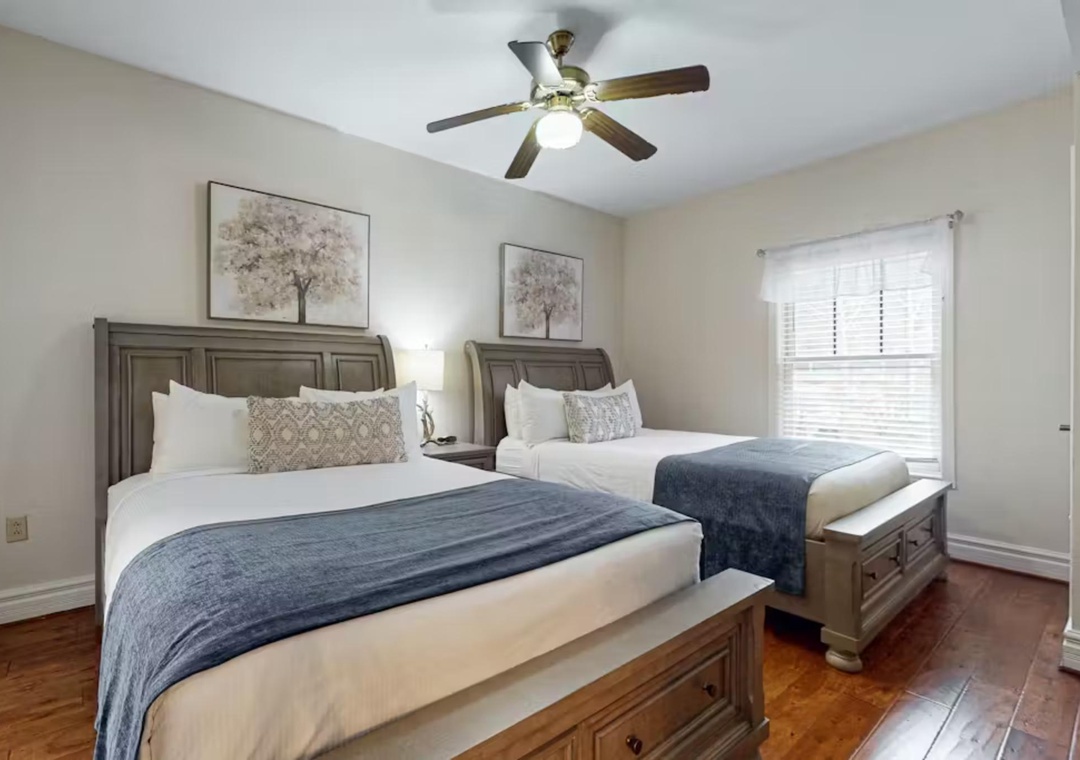 Rest peacefully in your twin bedroom with comfortable beds, calming decor, and natural light streaming through the windows.