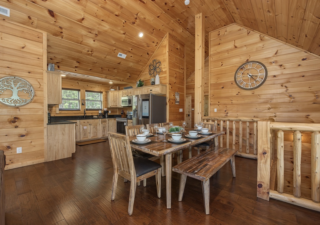 Gather around the rustic dining table in this warm wood cabin, where the open kitchen invites you to cook and share meals together beneath soaring vaulted ceilings.