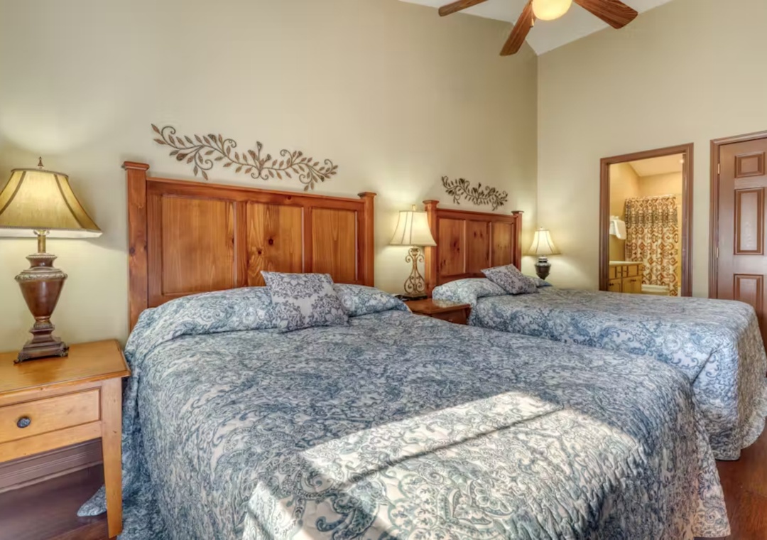 Settle into your comfortable twin beds with elegant paisley linens and charming rustic wood headboards in this thoughtfully appointed bedroom.