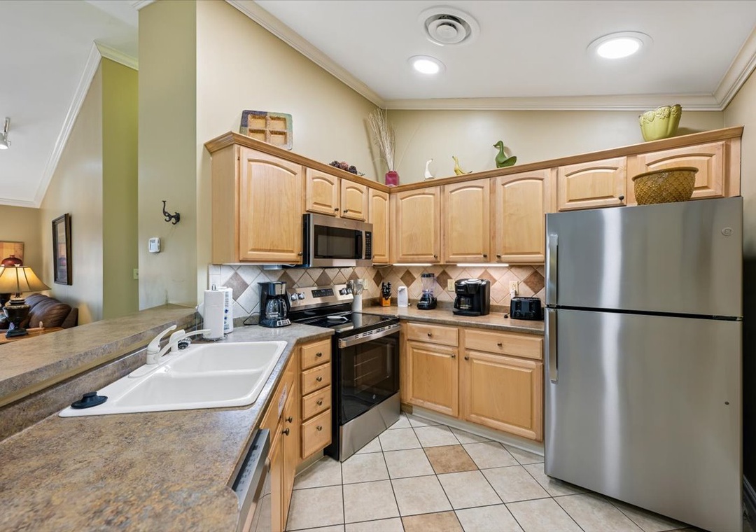 Your fully equipped kitchen awaits with stainless appliances, granite counters, and warm wood cabinets for preparing memorable meals together.