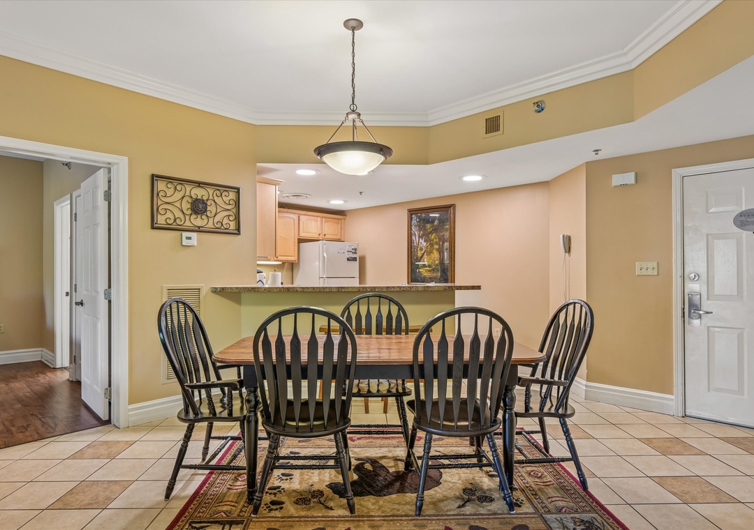 Gather around your spacious dining table where warm lighting and tasteful decor create the perfect setting for memorable meals together.