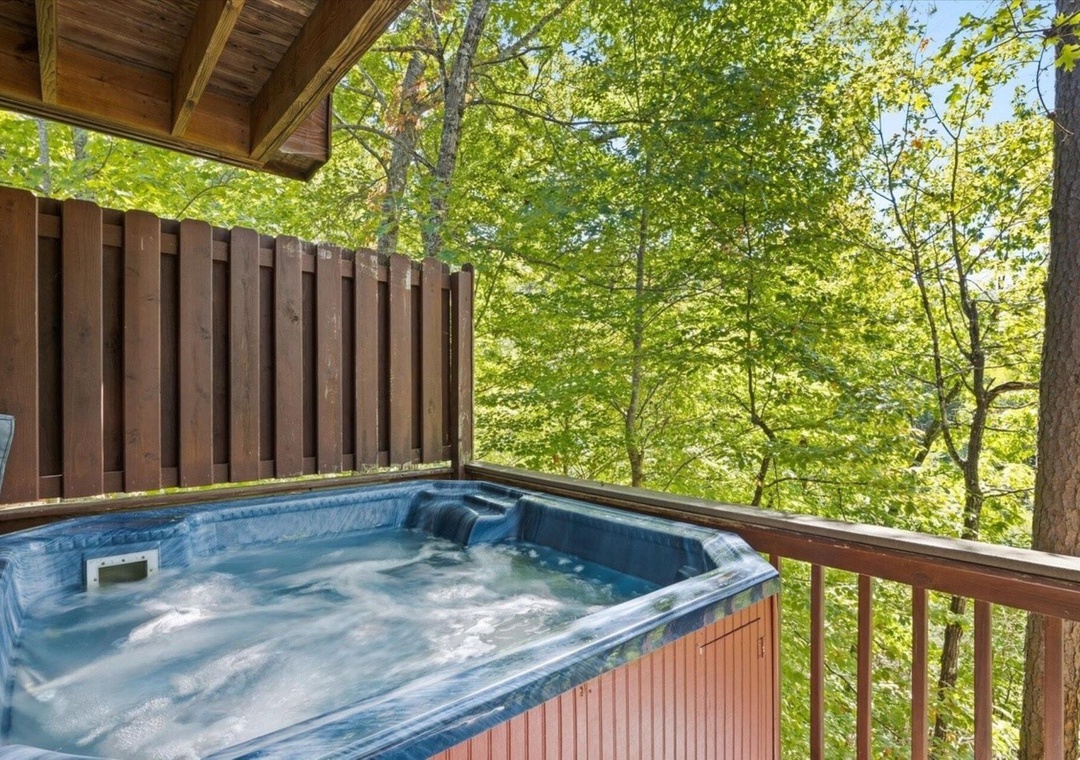 Soak in your private hot tub surrounded by towering trees and dappled sunlight filtering through the canopy.
