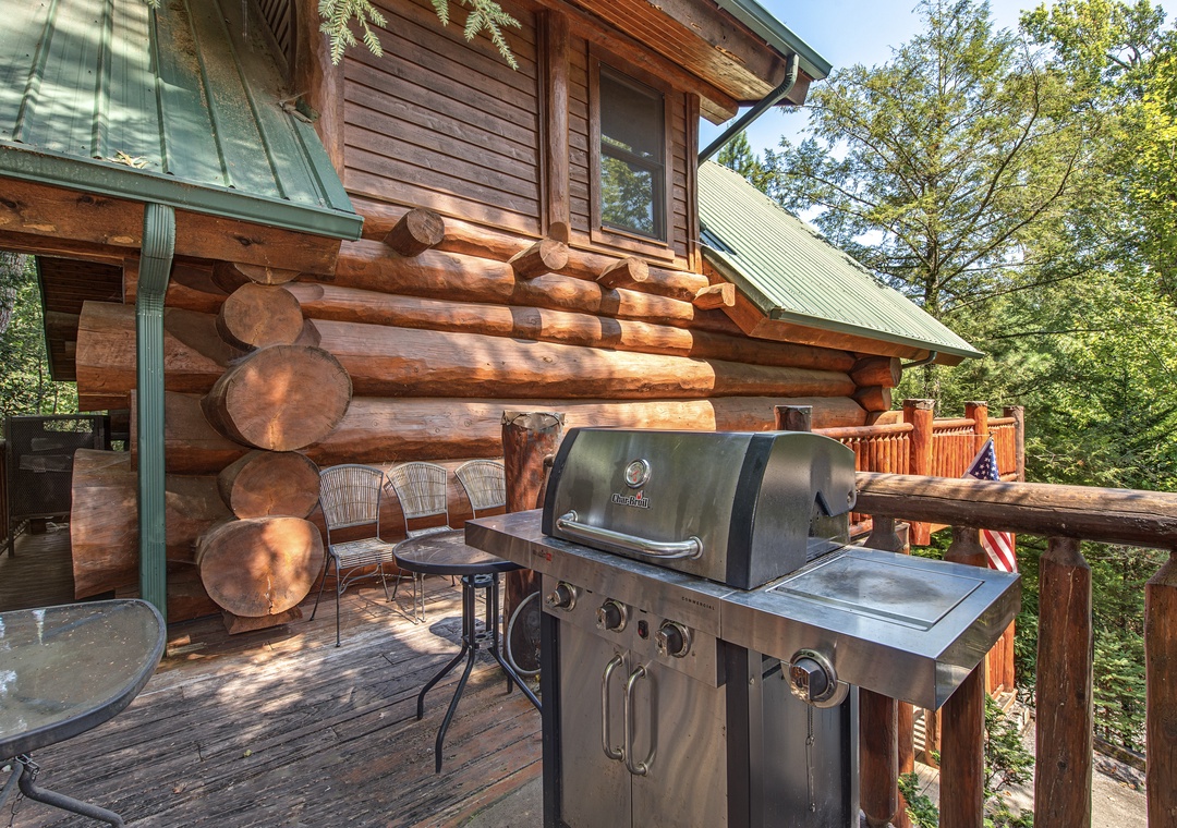 Fire up the grill on your private deck and savor the mountain air. This rustic log cabin retreat offers the perfect spot for outdoor cooking surrounded by lush forest.