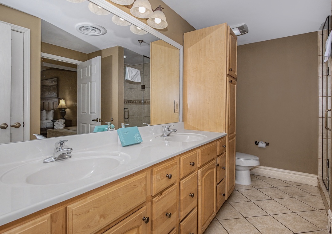 You'll love this spacious bathroom with dual sinks, ample storage, and a separate glass shower—perfect for your morning routine.