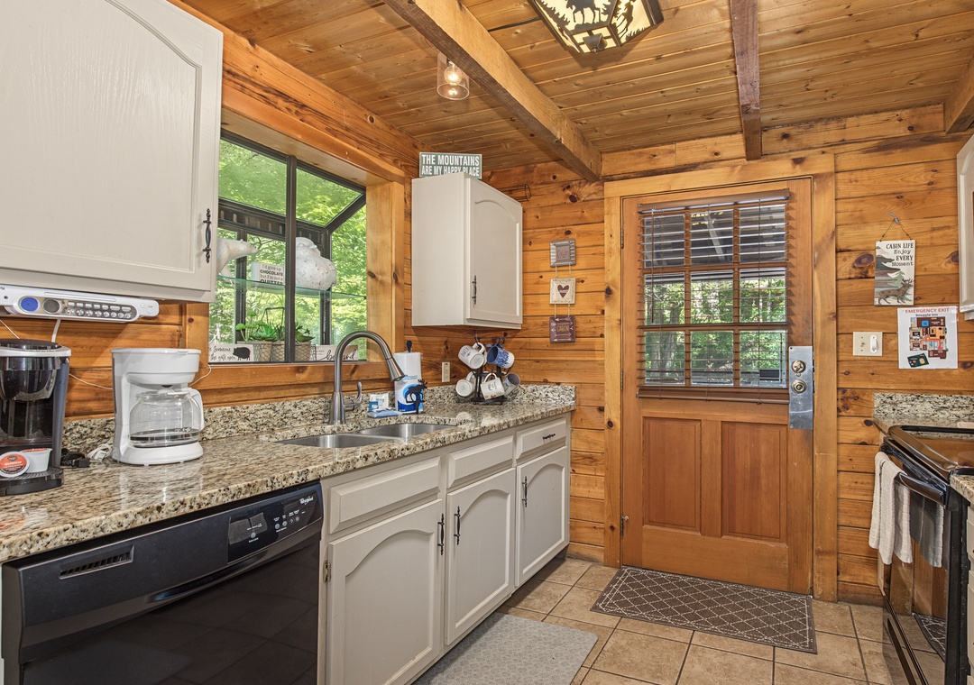 Cozy up in your cabin's fully equipped kitchen, where rustic wood beams and granite counters set the stage for your morning coffee rituals and homemade meals.