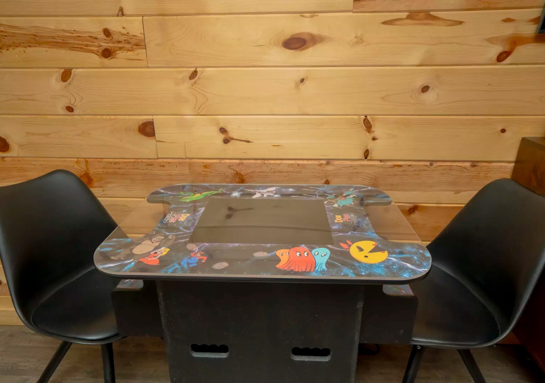 Gather around your family-friendly gaming table where arcade nostalgia meets cozy cabin charm—perfect for creating memories together.