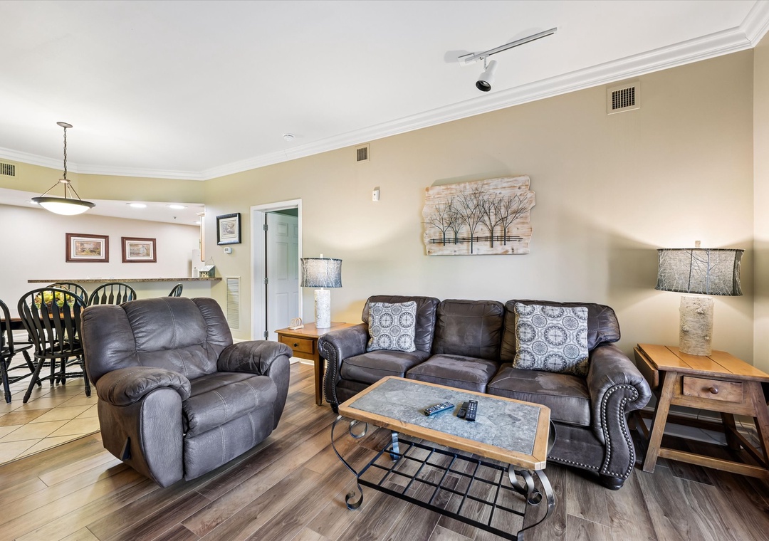Sink into plush leather seating in your spacious living room, where rustic charm meets modern comfort for perfect relaxation after your adventures.