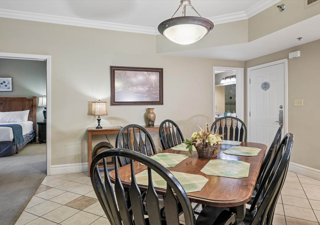Gather around this beautiful dining table where memorable meals await, with elegant lighting and classic charm perfect for your group.
