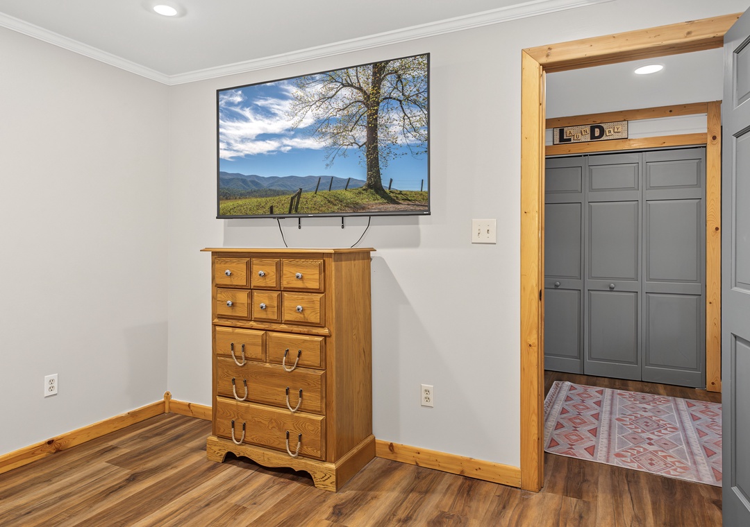 Step into your bedroom with warm wood accents, a cozy dresser for all your belongings, and a flat-screen TV ready for your favorite shows.
