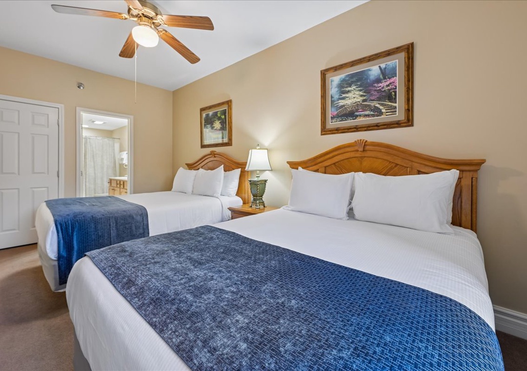 Rest peacefully in your comfortable twin bedroom with crisp linens, elegant headboards, and a gentle ceiling fan for perfect temperature control.