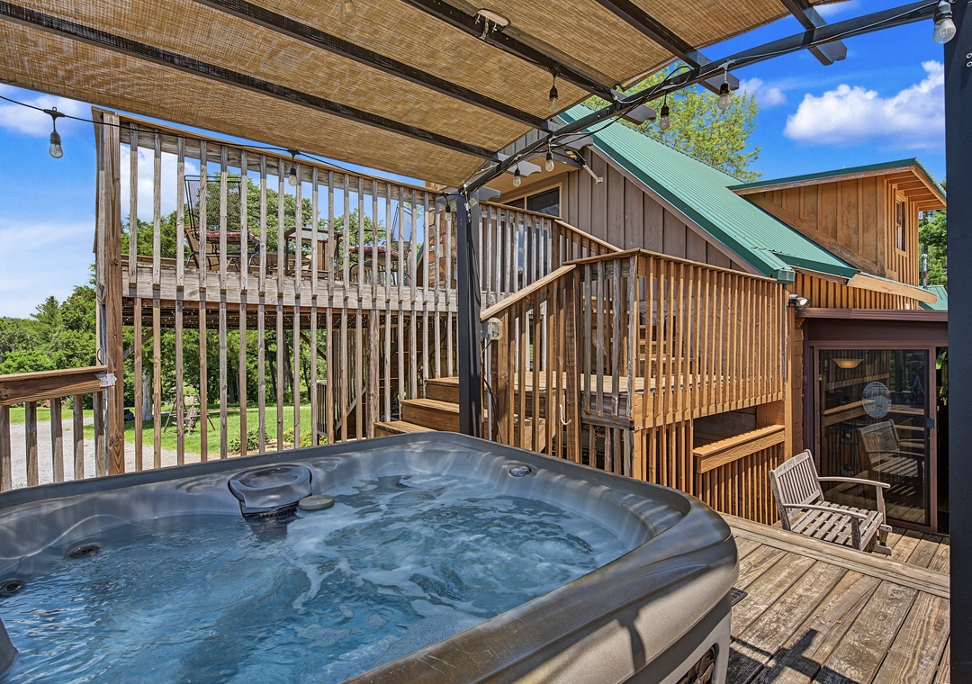 Soak in your private hot tub on the deck while enjoying mountain views and fresh air under a retractable awning. Perfect for unwinding after a day of adventure.