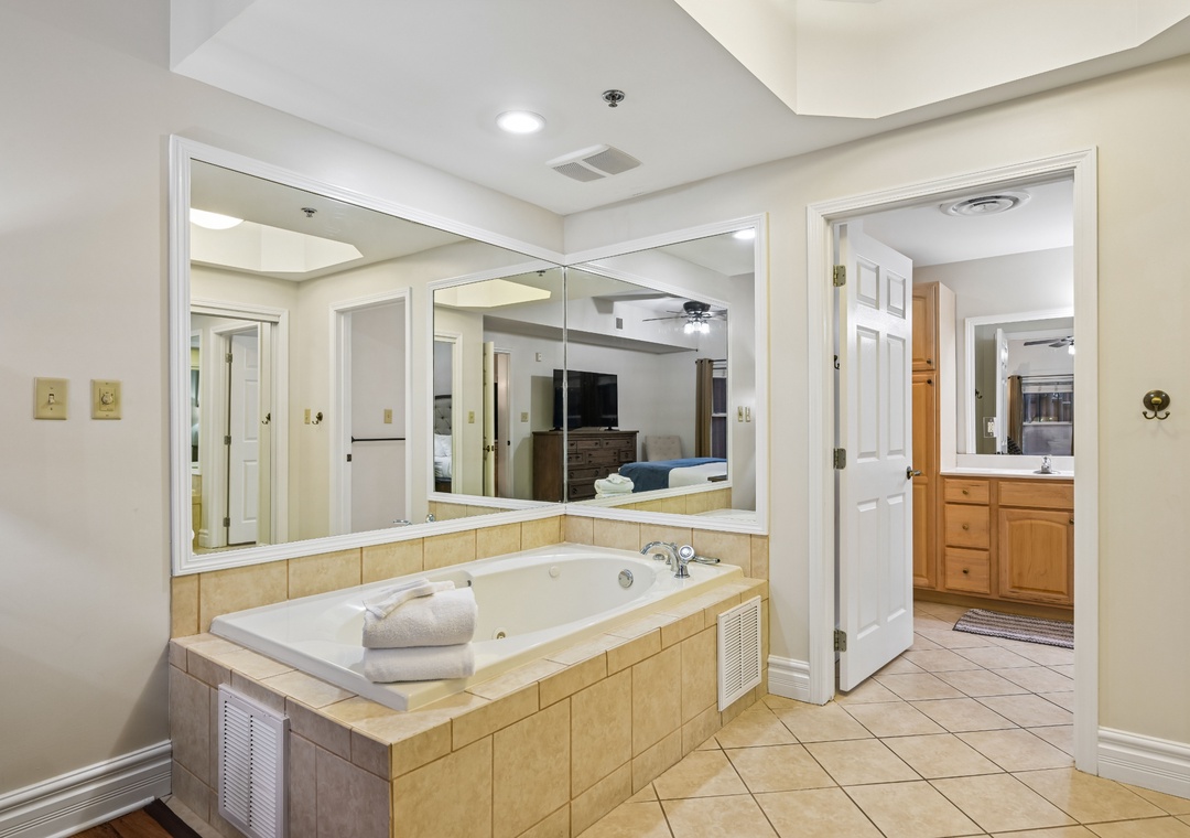 Slip into your private jetted tub surrounded by warm tile and mirrors, creating your perfect spa retreat.