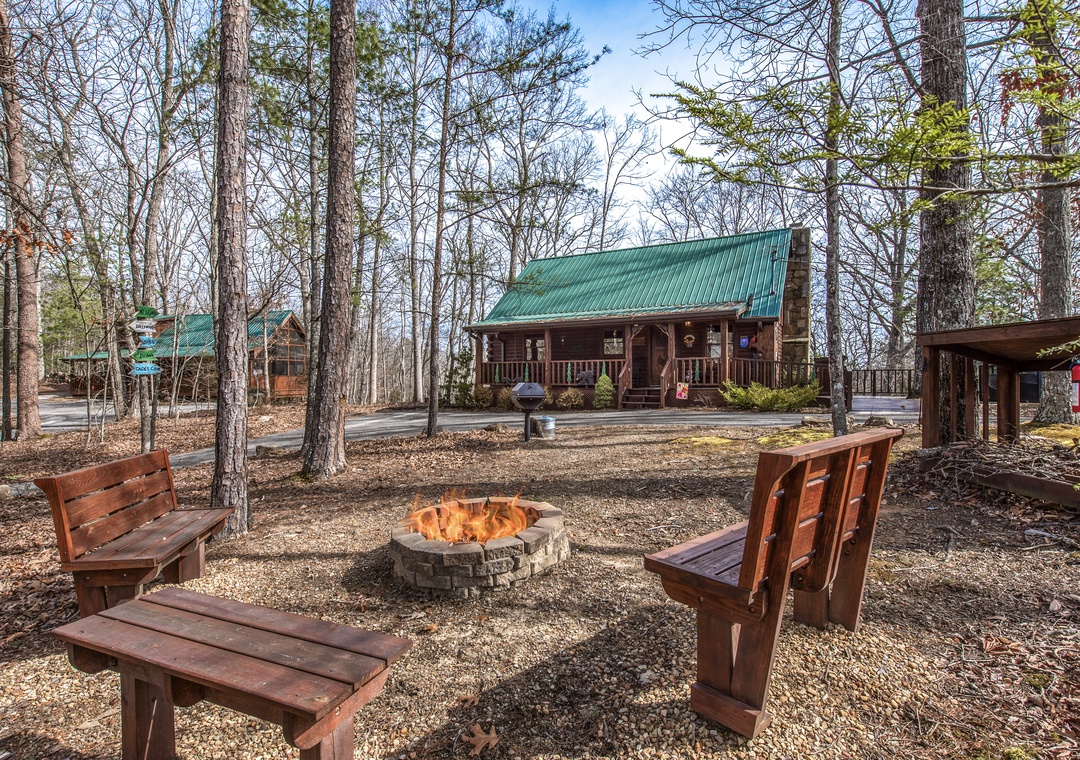 Gather around your private fire pit with rustic seating, perfect for evening stories under the stars in this peaceful wooded retreat.