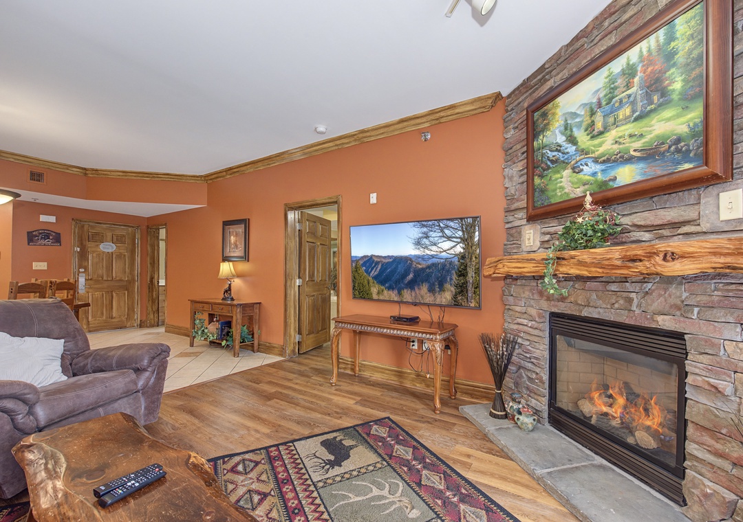 Cozy up by your crackling stone fireplace in this warm living space, perfect for unwinding after mountain adventures.
