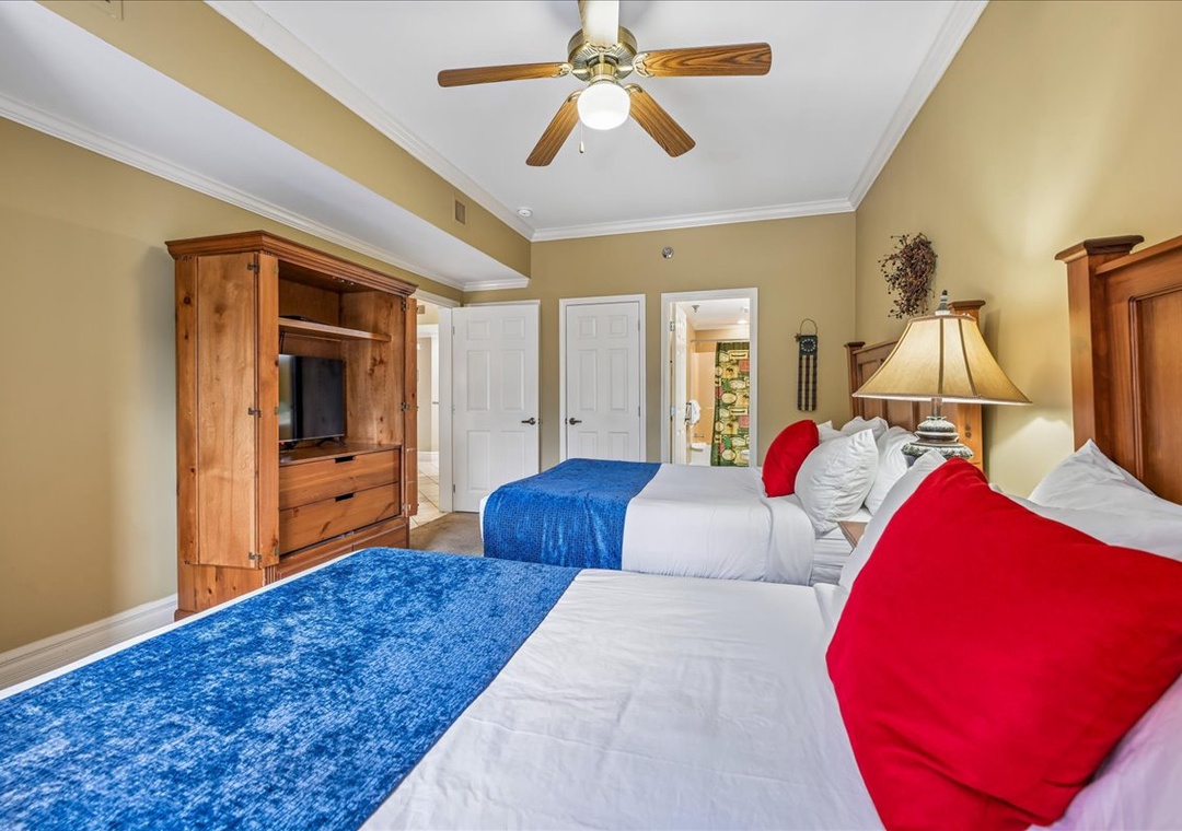 Relax in your spacious bedroom with twin beds, warm wood furnishings, and a ceiling fan to keep you comfortable.