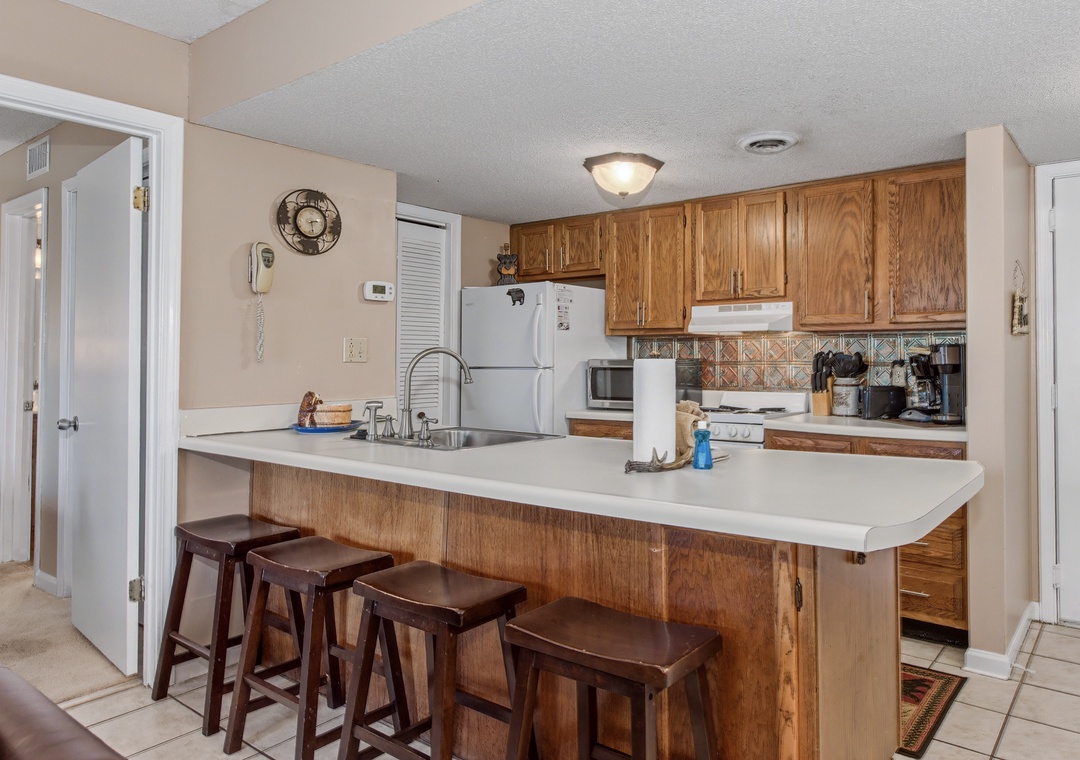 Your fully equipped kitchen with breakfast bar seating invites you to prepare meals and gather with loved ones in this warm, welcoming space.