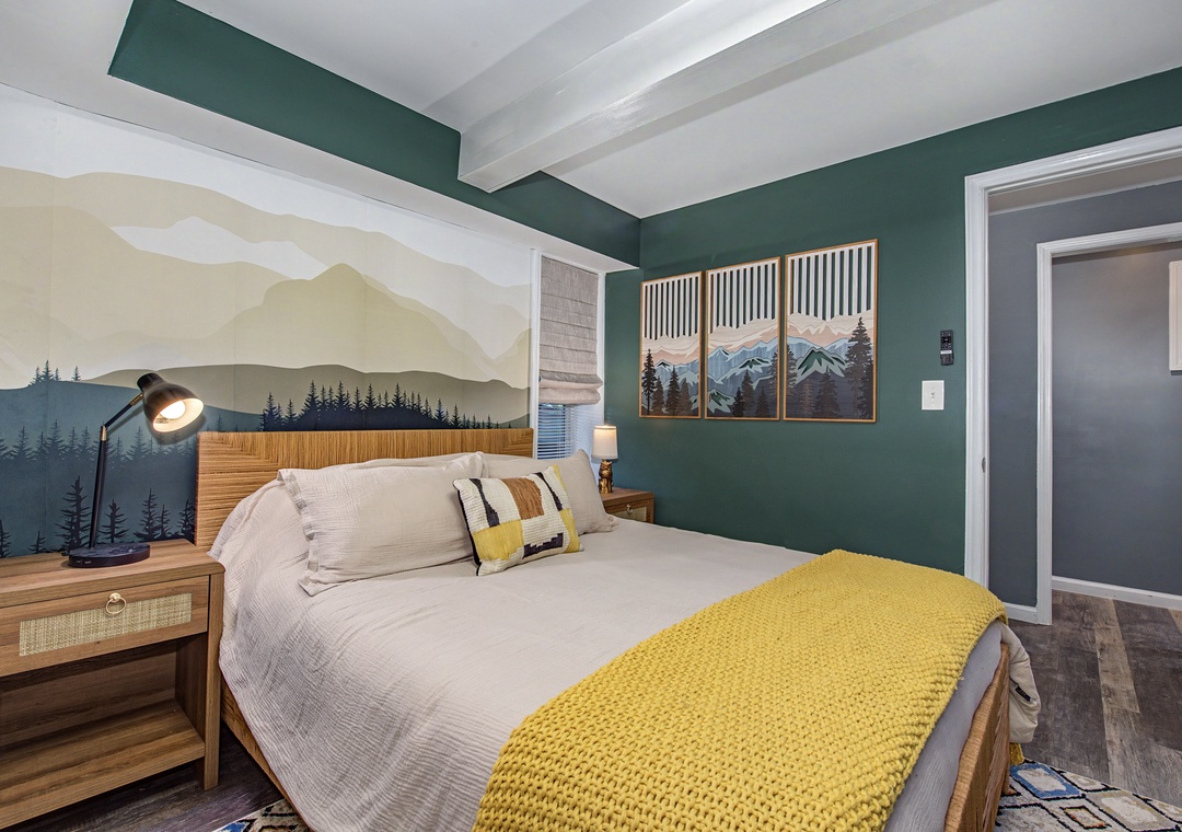 Sink into crisp linens and a plush mattress in your mountain-themed retreat, where stunning nature murals and thoughtful touches create the peaceful escape you've been craving.