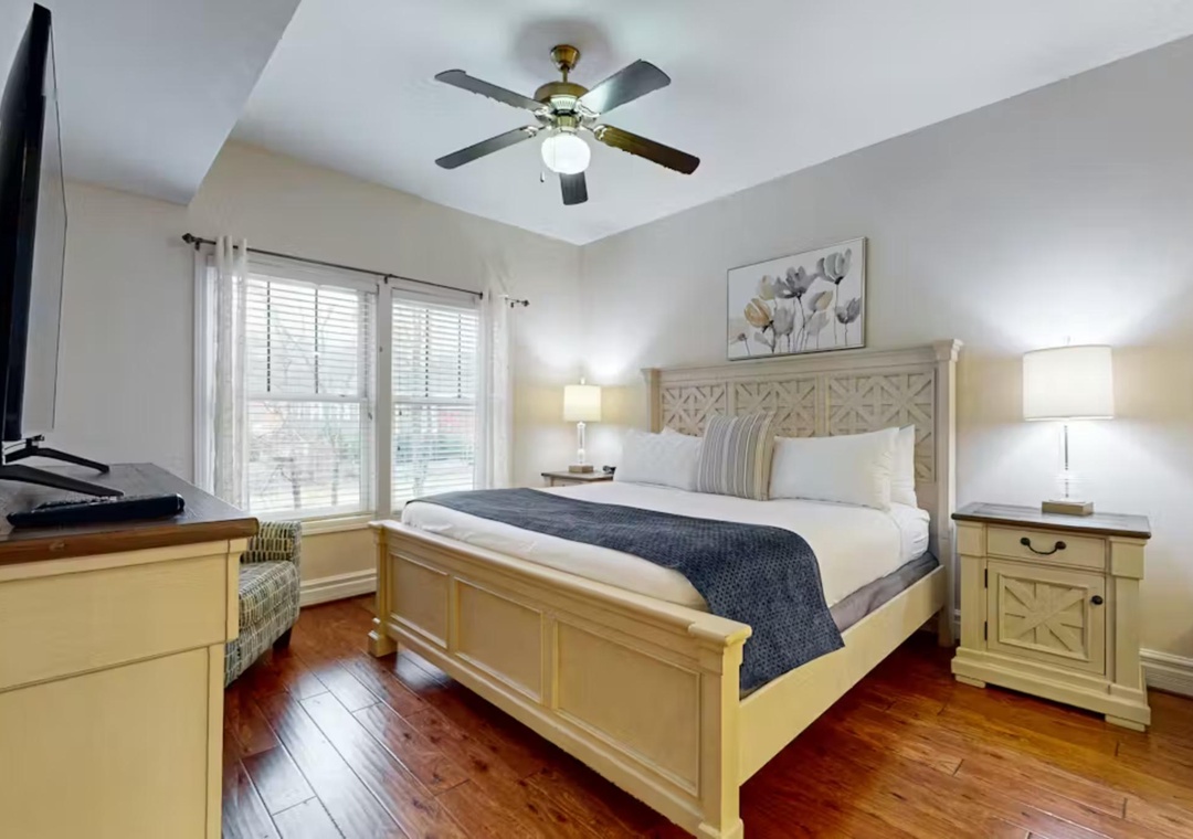 Unwind in your peaceful bedroom featuring a ceiling fan, soft lighting, and comfortable furnishings for perfect rest.