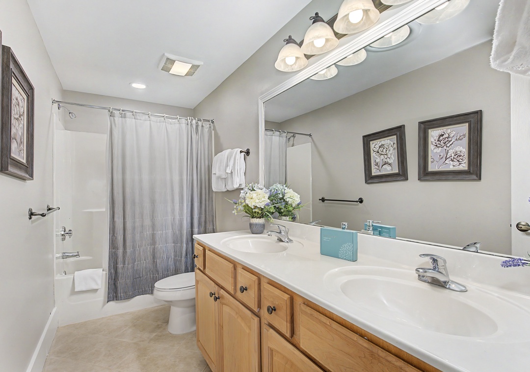 Your spacious bathroom features dual sinks and a relaxing tub-shower combo, perfect for unwinding after your adventures.