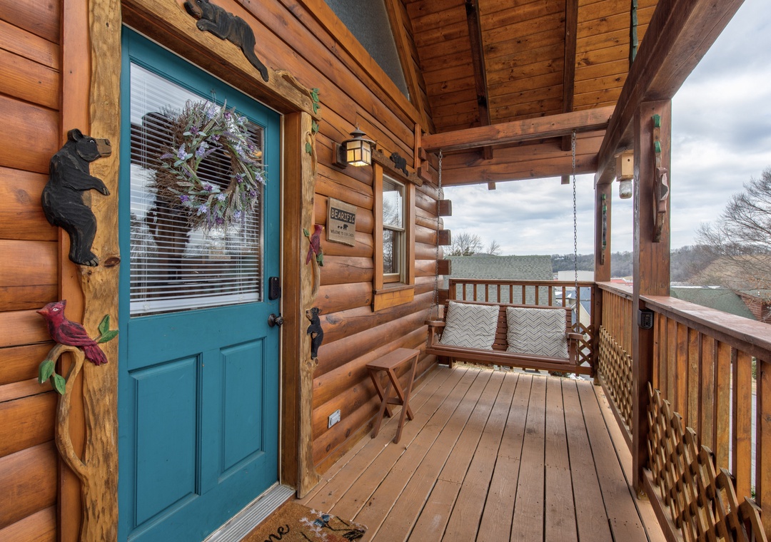 Step onto your welcoming front porch where rustic charm meets comfort, featuring a cozy swing with mountain views perfect for morning coffee.