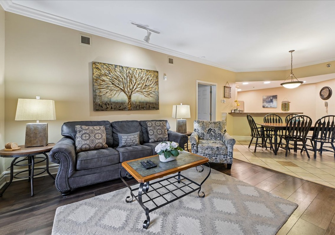 Relax in your spacious living room with plush seating and stylish decor, flowing seamlessly into the dining area.