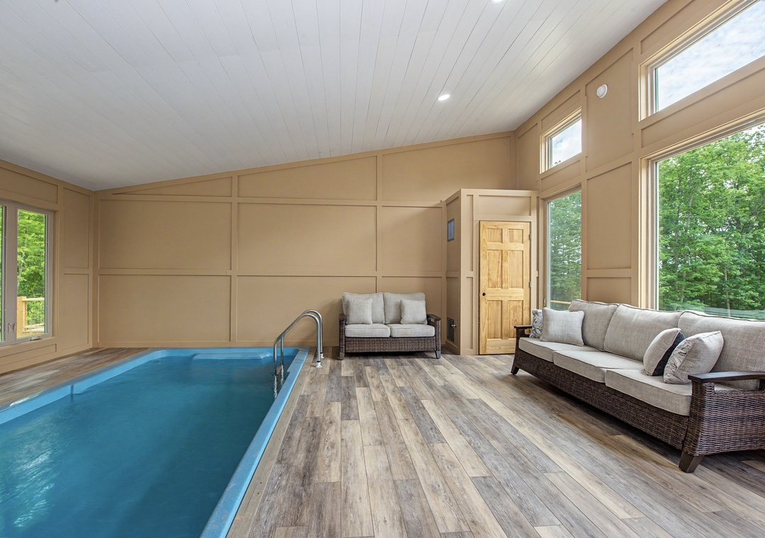 Step inside your own private pool retreat with vaulted ceilings and garden views—a tranquil escape where comfort meets relaxation.