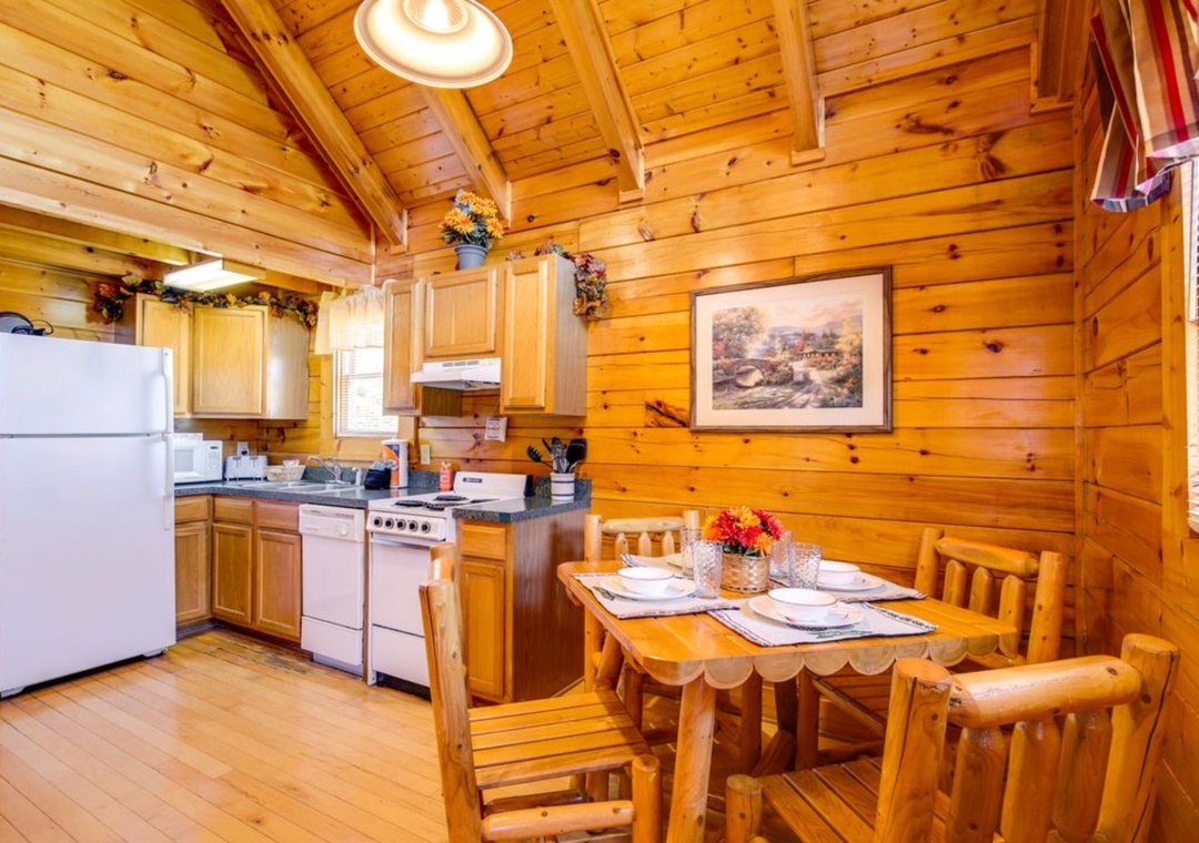 Your rustic cabin kitchen invites cozy meals with warm wood walls, full appliances, and a charming dining nook.