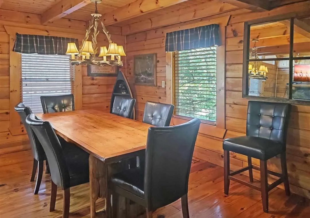 Gather around this rustic dining table where warm wood walls and soft lighting create the perfect atmosphere for memorable meals together.