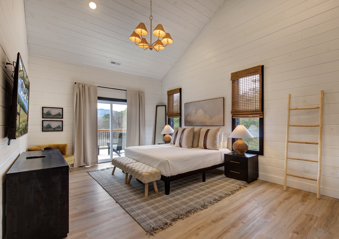 Relax in your peaceful bedroom sanctuary, featuring vaulted ceilings, cozy mountain views, and modern comforts for the perfect retreat.