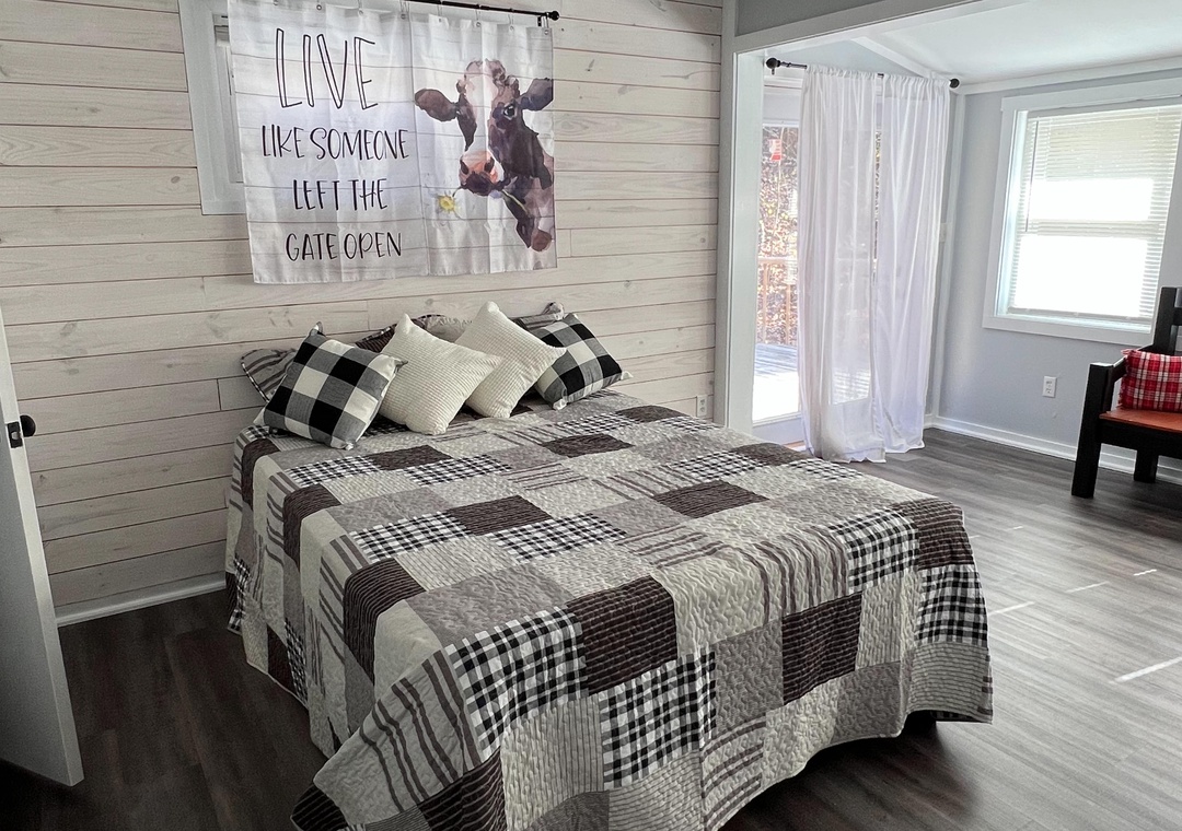 Drift off to peaceful slumber in your cozy farmhouse bedroom with charming plaid bedding and rustic touches.