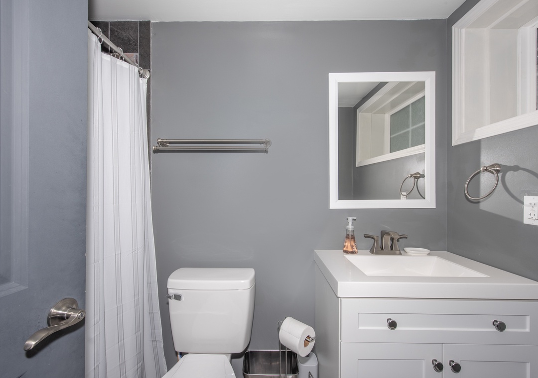 Step into your private bathroom with modern finishes, fresh white cabinetry, and a soothing gray palette that invites you to unwind after a day of adventure.