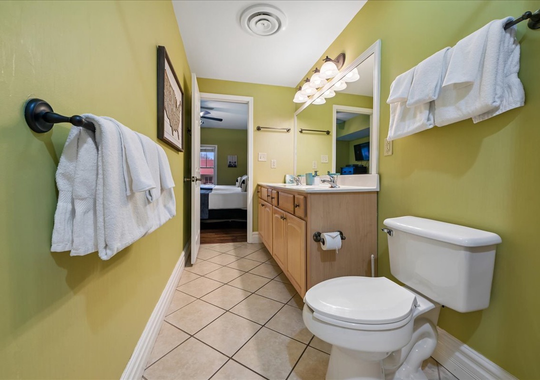 Your bright, cheerful bathroom awaits with fresh towels, warm lighting, and everything you need for a comfortable stay.