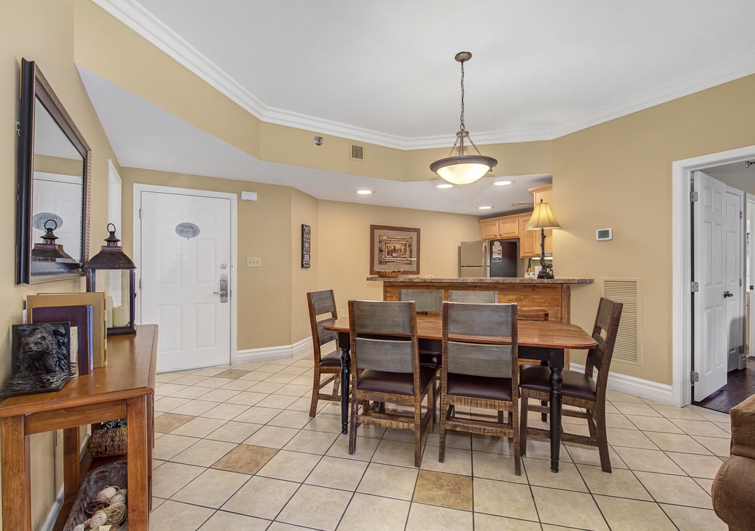 Gather around this warm dining space where your group can share meals together, with an open kitchen just steps away for easy entertaining.