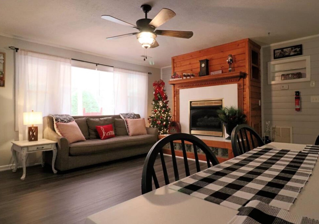 Unwind in your cozy living space with plush seating, warm fireplace, and festive touches that make every moment feel like home.