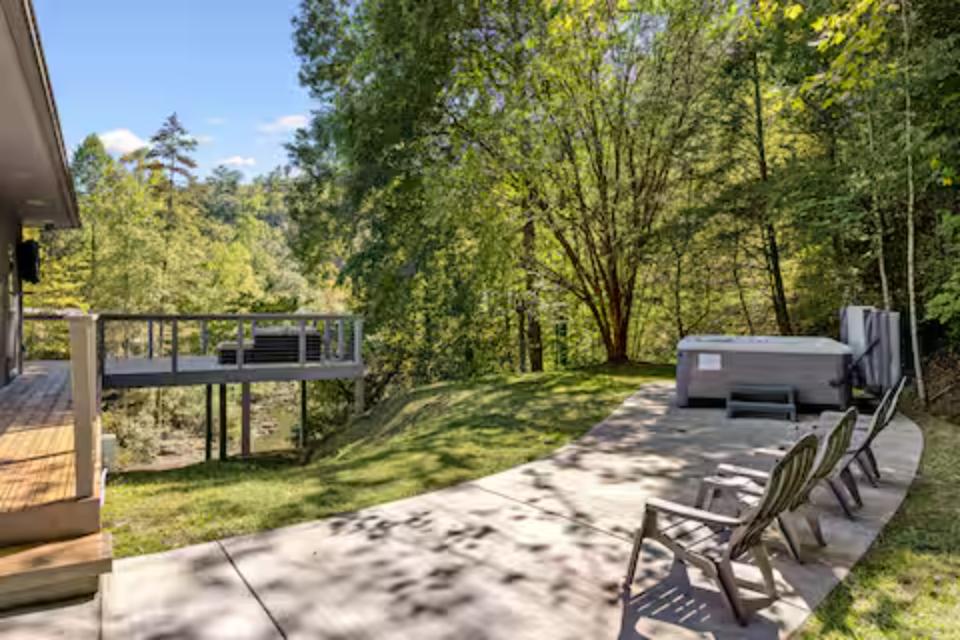 Soak in your private hot tub surrounded by lush forest views, then relax on the spacious deck with outdoor seating overlooking peaceful woodland.