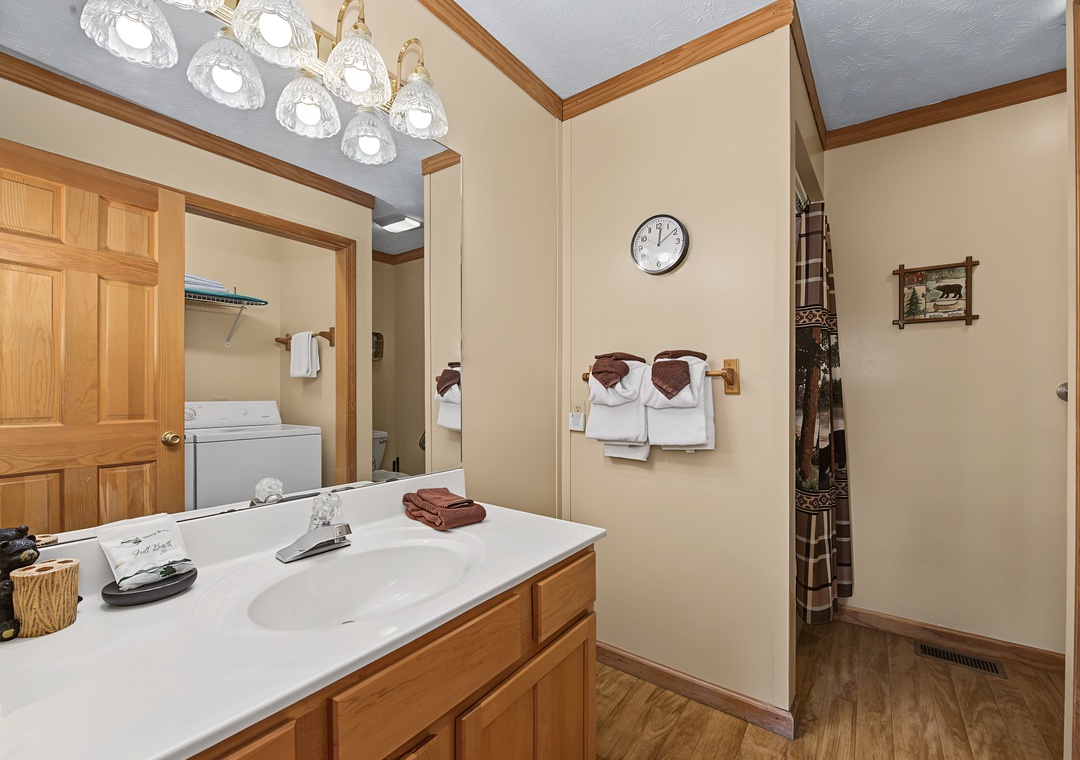 Step into your private bathroom where fresh towels await and a nearby washer-dryer makes packing light effortless.