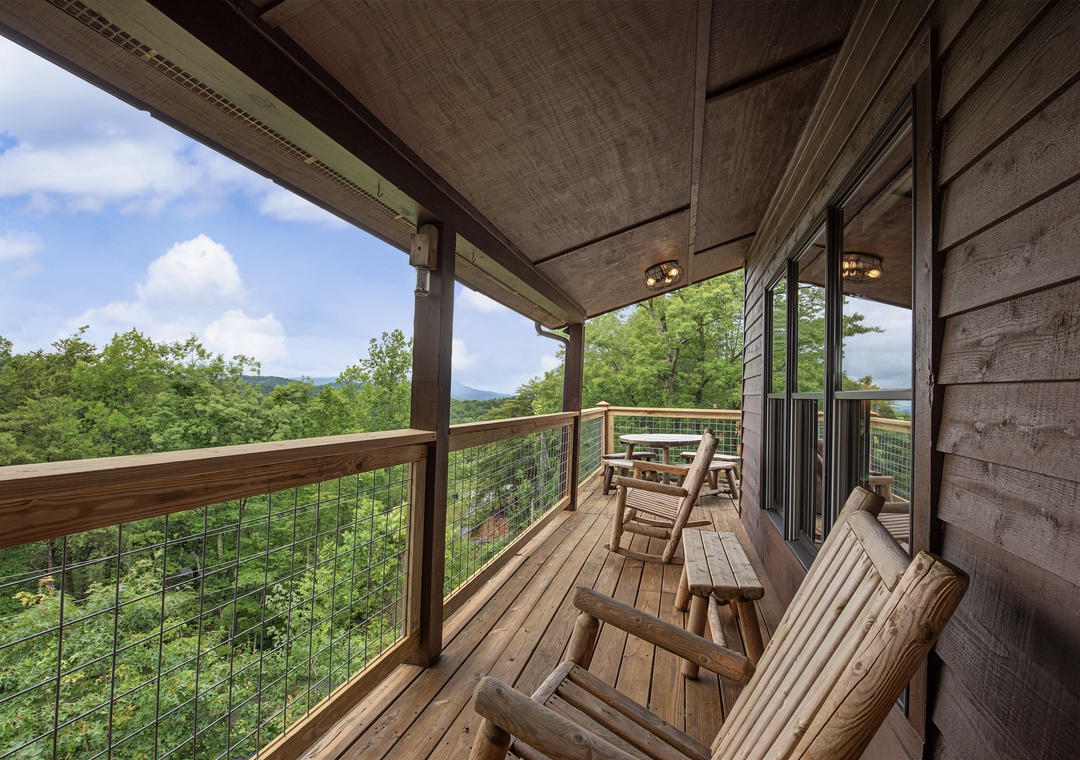 Settle into your private deck and soak in sweeping mountain views. Relax in handcrafted rocking chairs, breathe in the fresh air, and watch the treetops sway beneath distant peaks.