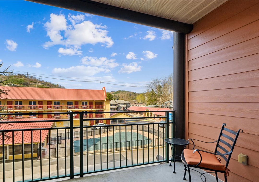 Relax on your private balcony with poolside views and mountain scenery stretching beyond.