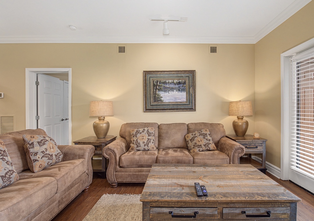 Sink into plush sofas and unwind in your elegantly appointed living room, where warm lighting and thoughtful touches create the perfect retreat.