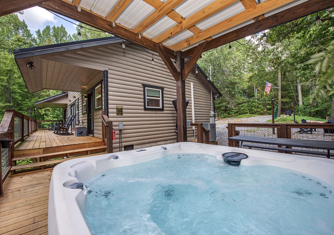 Unwind in your private hot tub under the sheltered deck, where forest views and fresh air create the perfect spot to relax after a day of adventure.