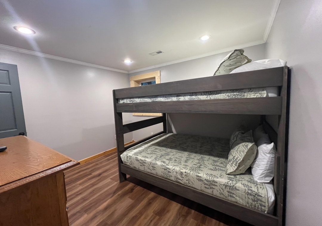 Your cozy bunk room with freshly made beds and warm wood floors—perfect for the kids or extra guests to settle in comfortably after a day of adventure.