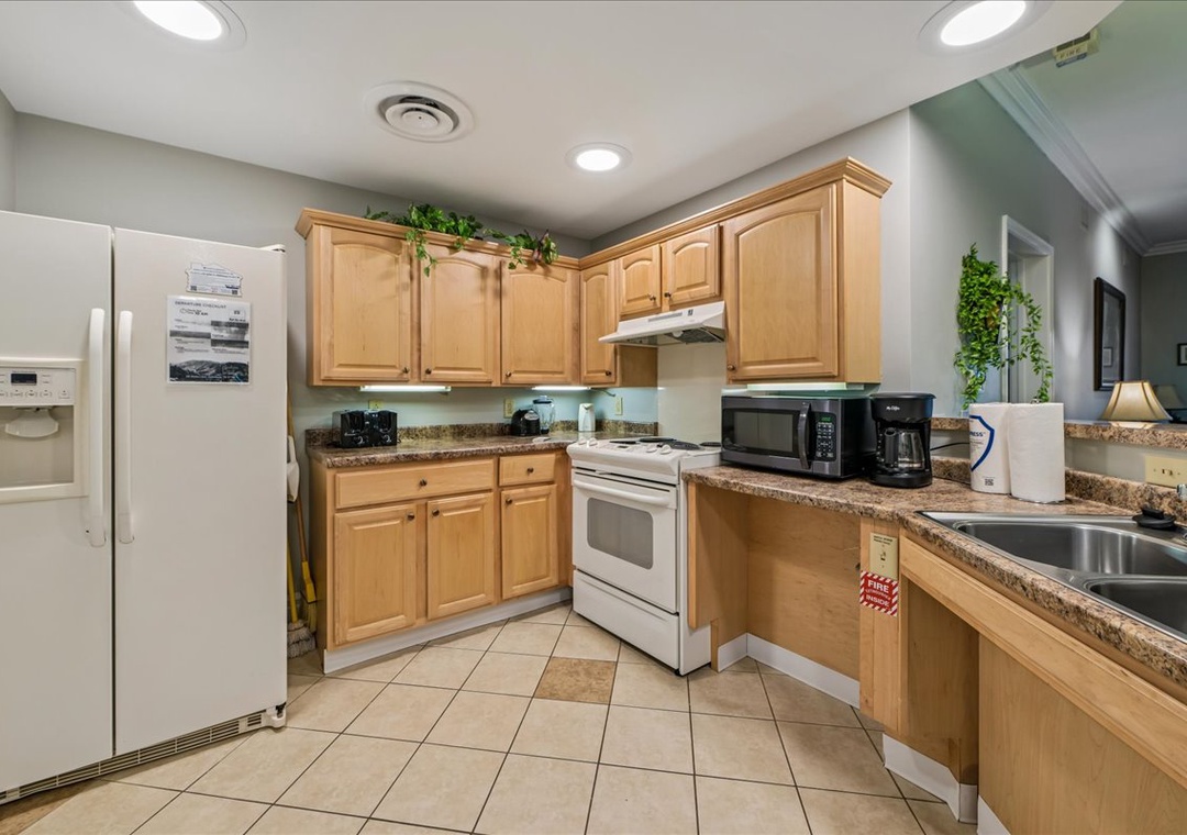 Your fully equipped kitchen awaits with granite countertops, modern appliances, and warm wood cabinets for memorable meal prep.