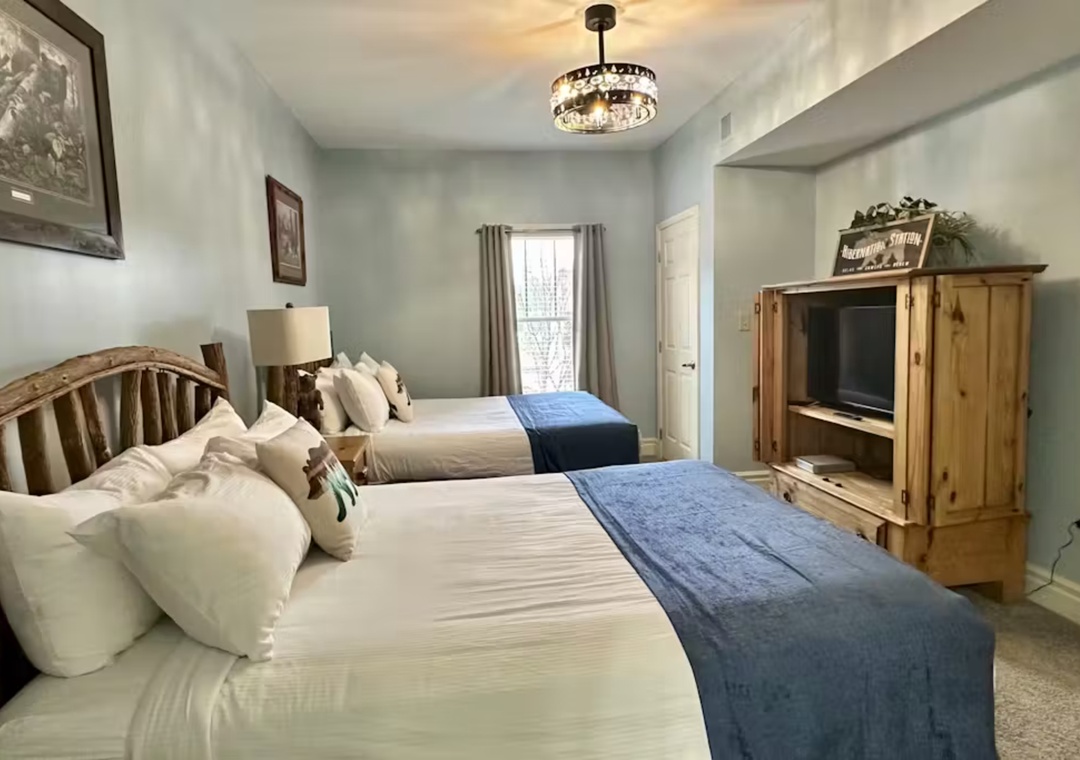 Unwind in your cozy retreat with two comfortable beds, rustic charm, and modern touches including a TV for relaxing evenings.