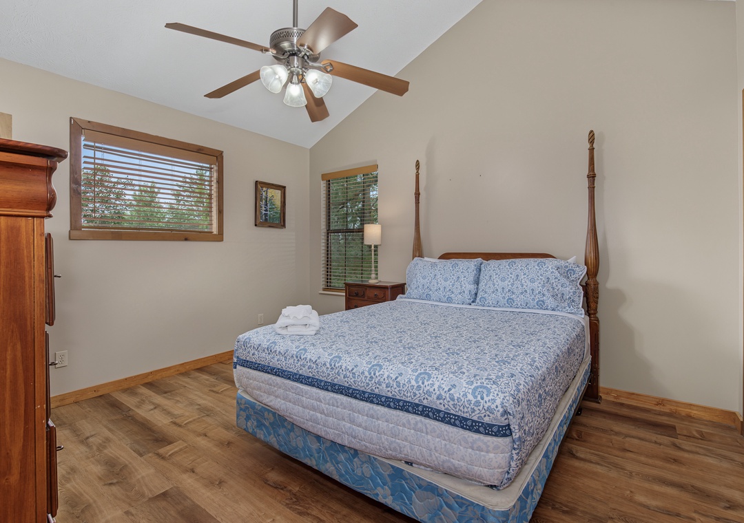 Rest easy in this peaceful bedroom where crisp linens and natural light create your serene retreat. The vaulted ceiling and gentle ceiling fan keep you comfortable throughout your stay.