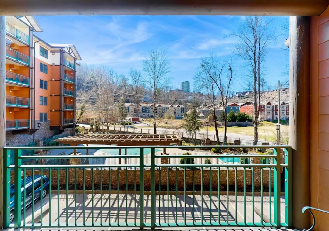 Step onto your private balcony and take in the peaceful neighborhood views, where colorful buildings and blue skies create a perfect backdrop for your morning coffee.