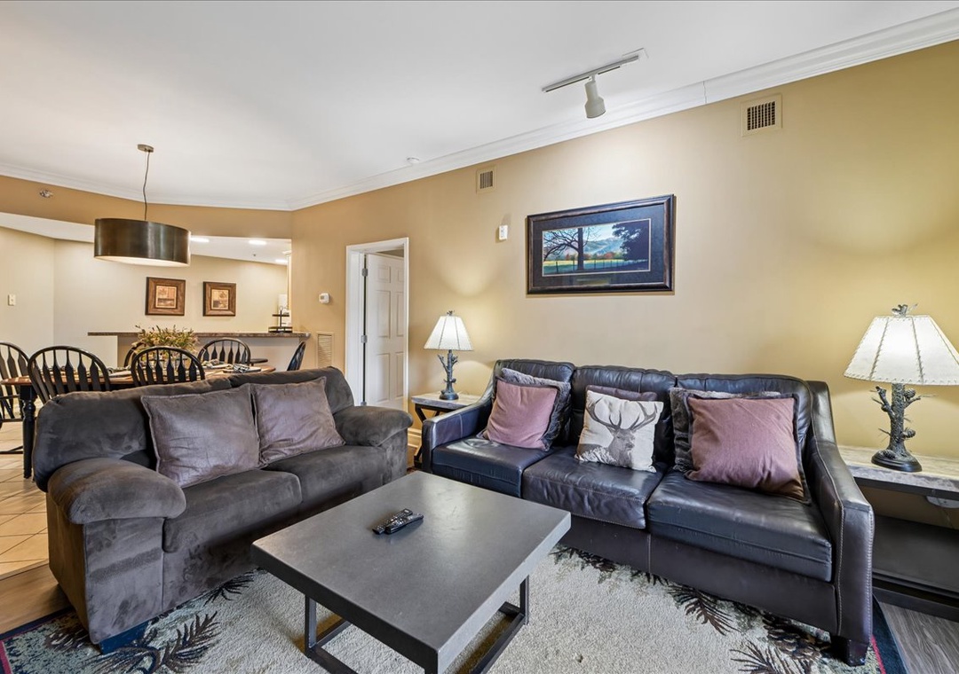 Sink into plush leather sofas in your spacious living room, where warm lighting and thoughtful décor create the perfect atmosphere for relaxing evenings.