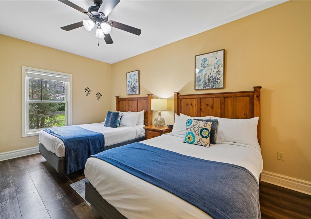 Relax in your cozy twin bedroom with warm wood furnishings, crisp linens, and a peaceful garden view to start each morning refreshed.
